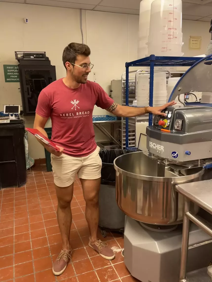 Martinucci shows off “Esther” the mixer, which can mix up to 100 loaves worth of dough at a time. - ASHLEE REDGER