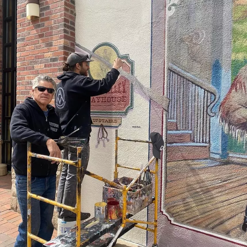 Will Krieg (right) repainting one of Chris Krieg's (left) original murals in Golden, CO. -ANDREW VASKO