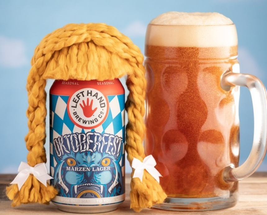 a can of beer with a braided hair wig next to a mug of beer