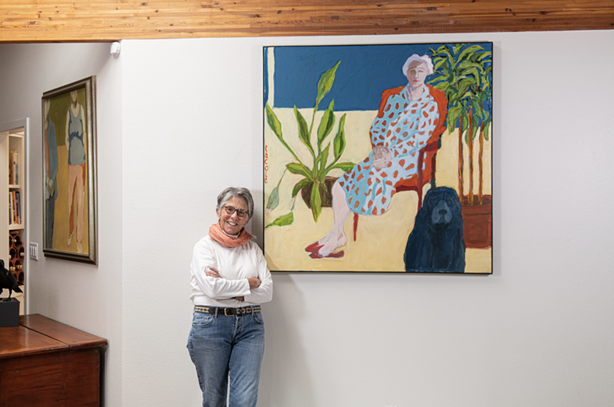 Kathryn Cole next to one of her paintings.