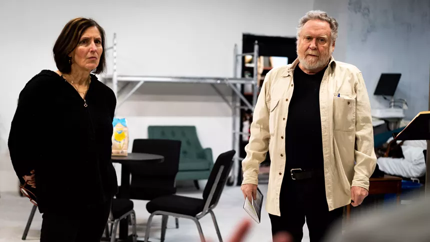 a woman in a black hoodie and a man in a white jean shirt