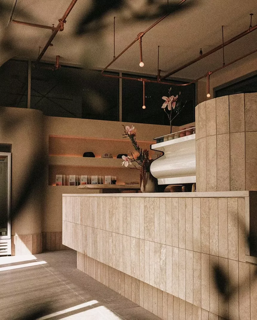 a counter covered in wood panels inside a coffee shop