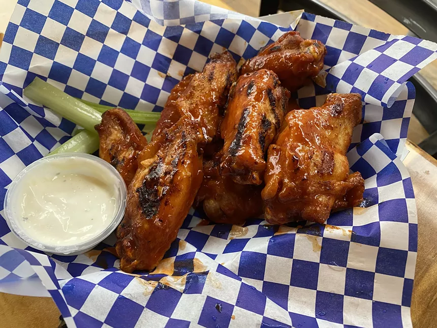 a basket of grilled chicken wings