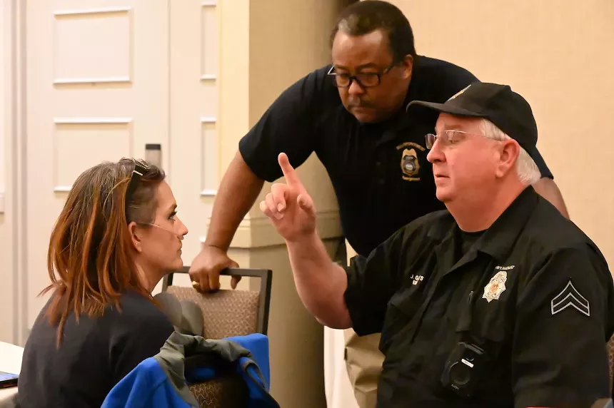 Police perform an intoxication test on a volunteer after she ate an edible at a driver awareness event