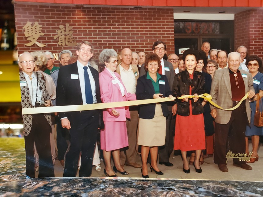 a group of people at a robbon cutting ceremony