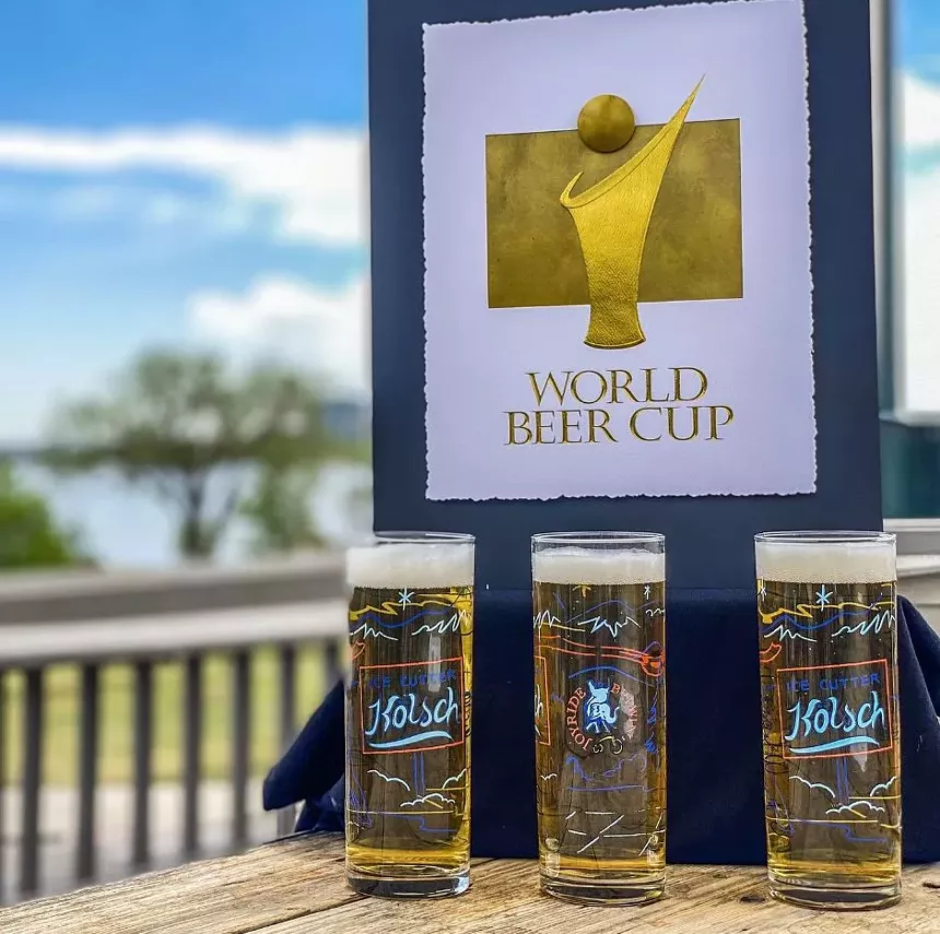 three glasses of beer below a World Beer Cup sign.