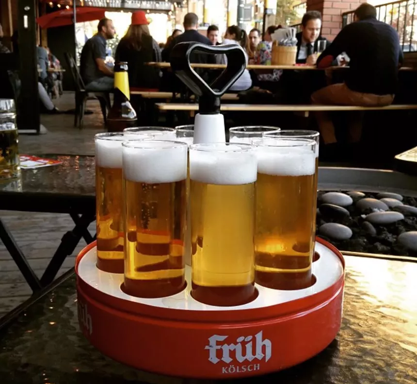 A tray of beers on a table outside