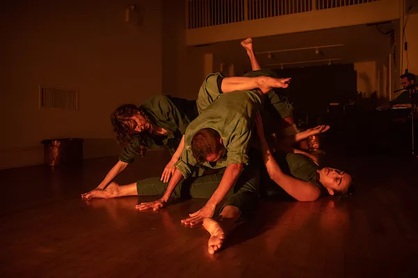four people engaged in interpretive dance