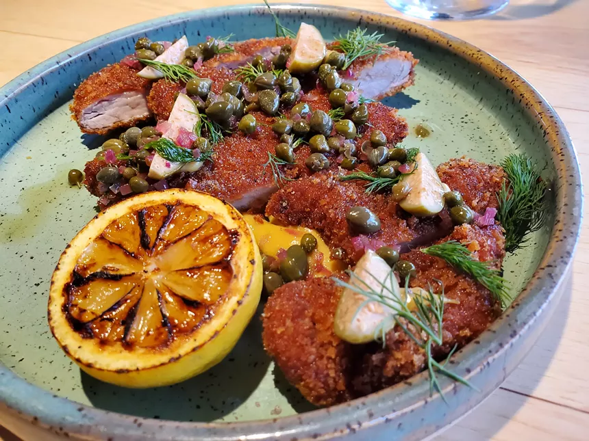 fried pork schnitzel with a grilled lemon half