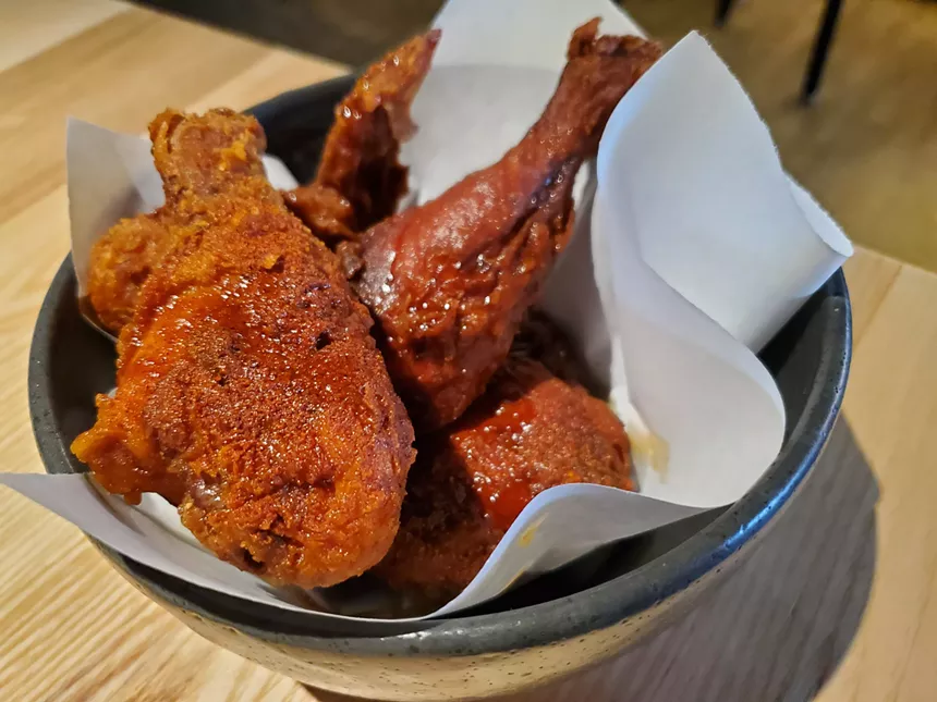 several pieces of fried chicken drizzled with hot honey