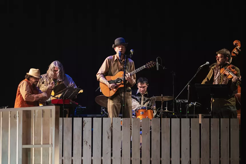 an acoustic band playing on stage