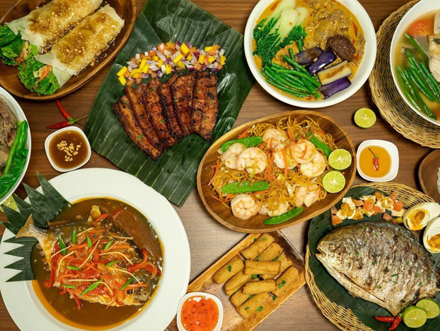 Multiple plates of traditional Filipino food