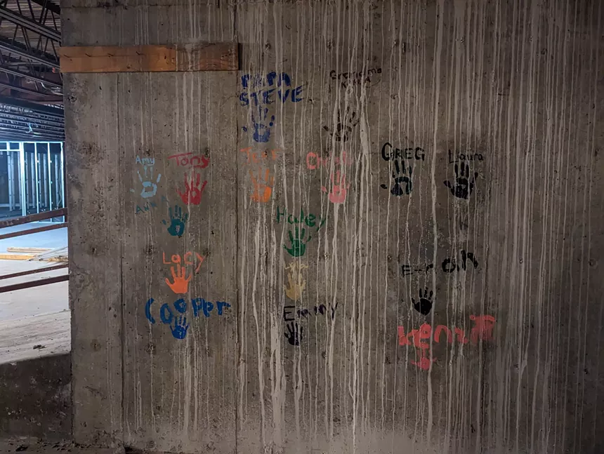 a wall with handprints painted on it