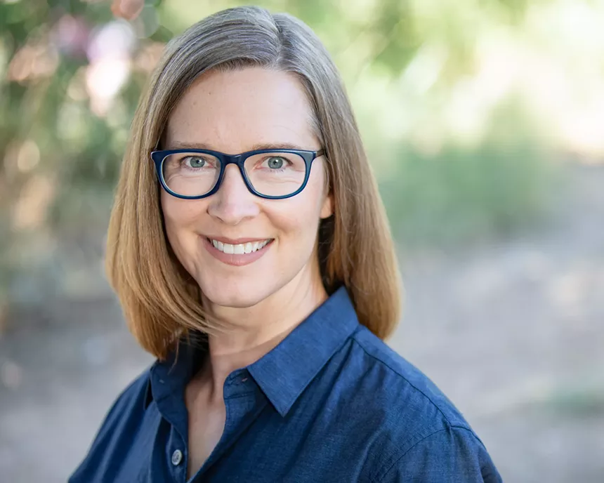 a woman with blue glasses
