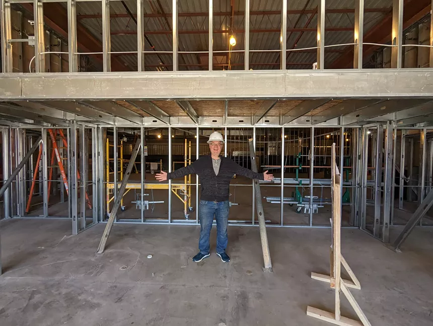 a person standing in a room under construction