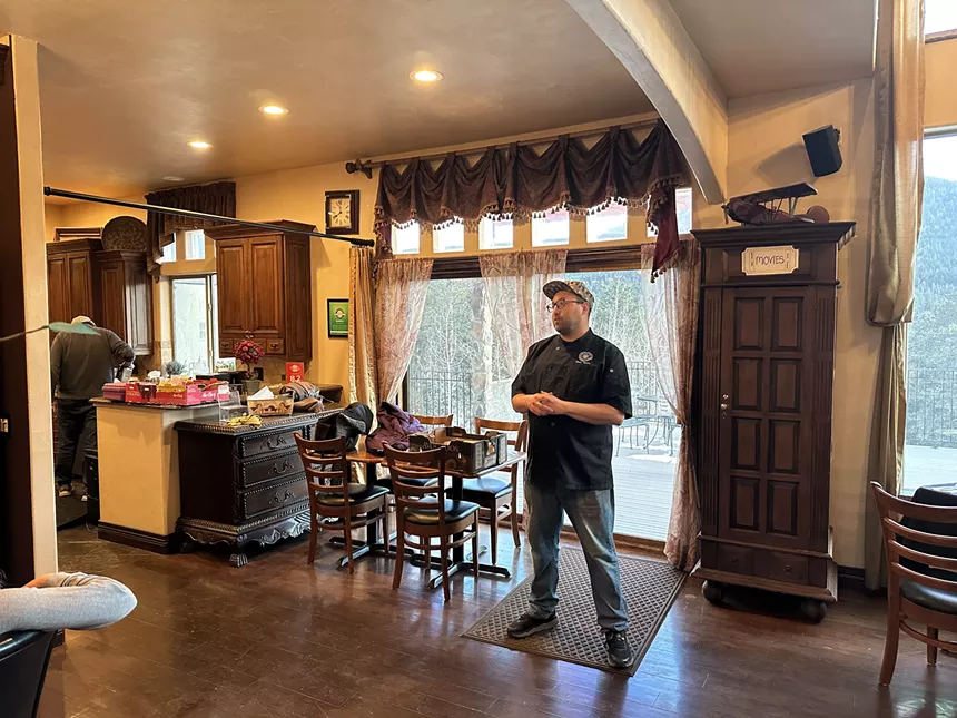 Jarod "Roilty" Farina speaks to guests at the Arrowhead Manor before a weed-infused dinner.