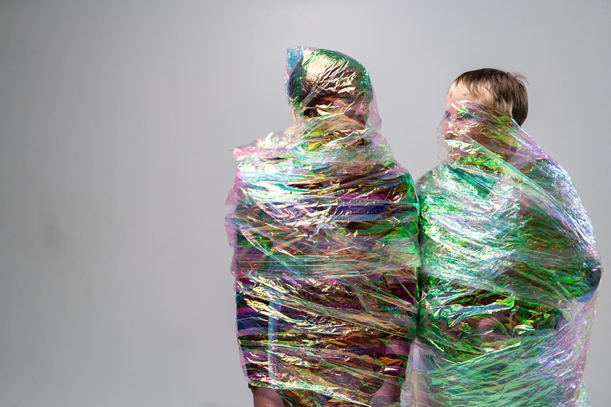 two people wrapped in plastic