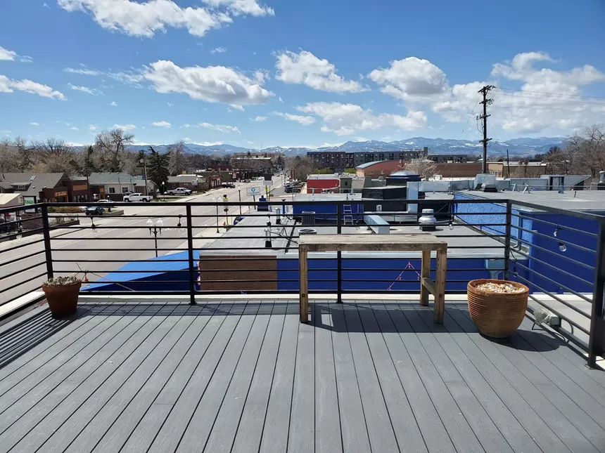 a rooftop deck with mountain views
