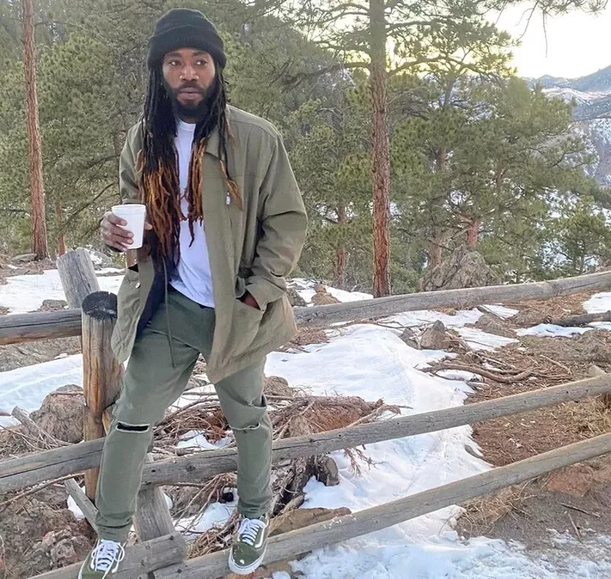 man outside Colorado with coffee