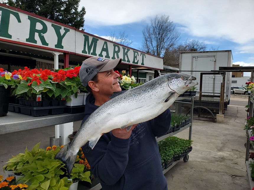 a man holding a large salmon
