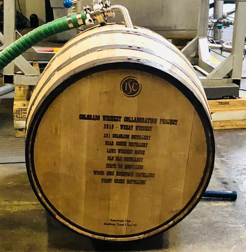 Whiskey barrel being filled.