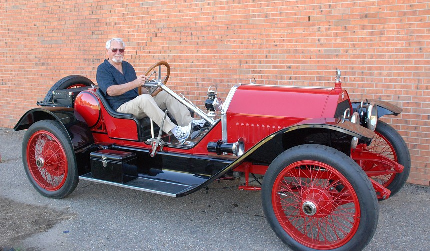 clive cussler in antique red car
