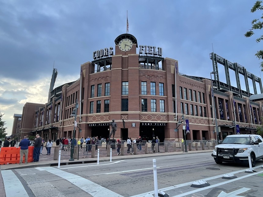 The home plate entrance to Coors Field, a giant brick baseball stadium, without much activity.