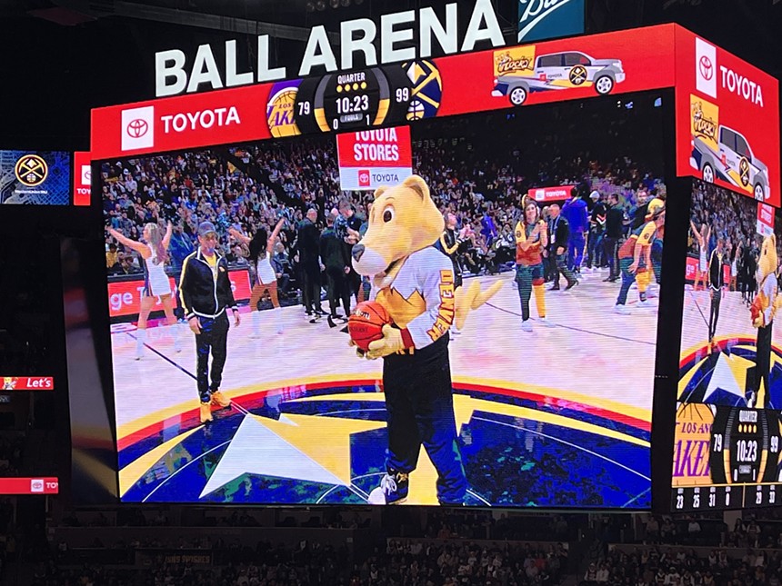 Man behind original mascot watches other Rocky.