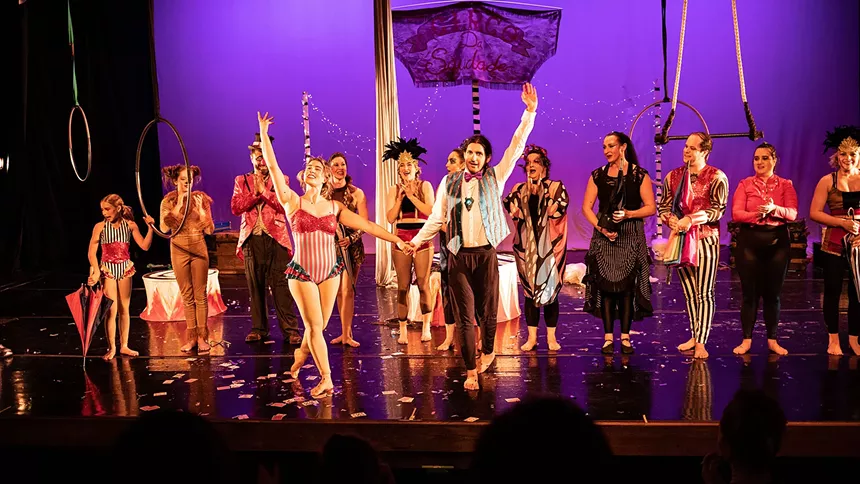 circus troupe stands on stage for an encore
