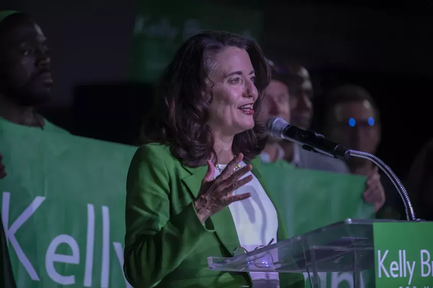 Kelly brough candidate at microphone