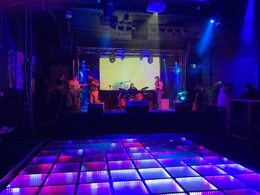 band plays in front of a colorful dance floor