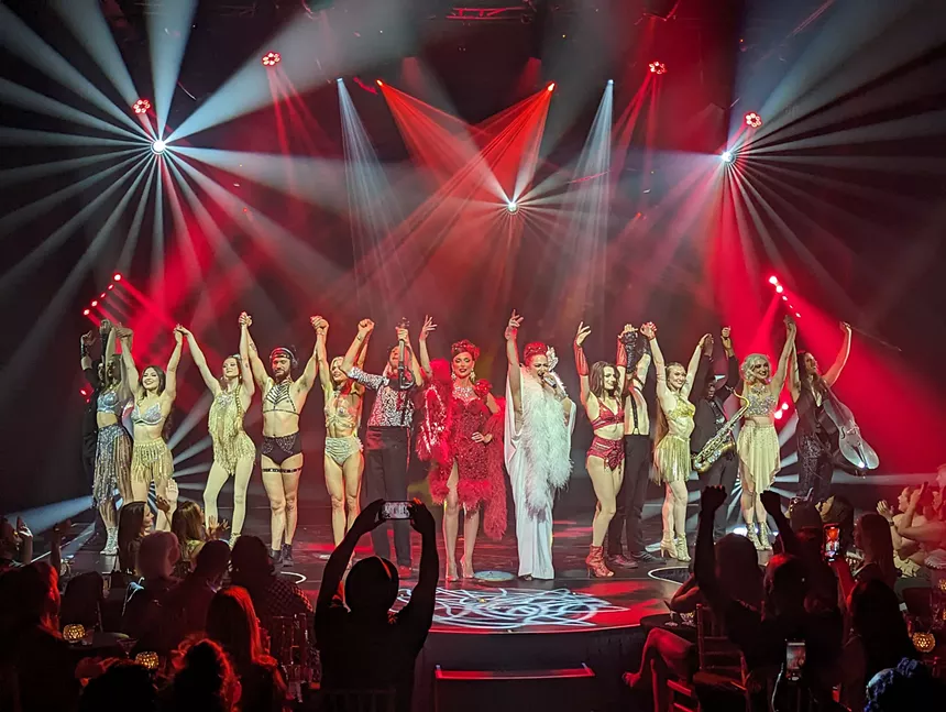 a cast on stage takes a bow