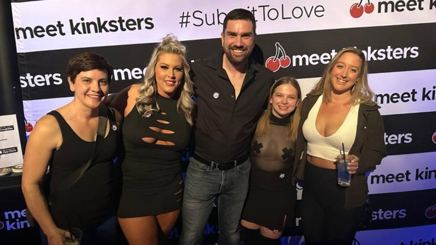man with four women at kinky party
