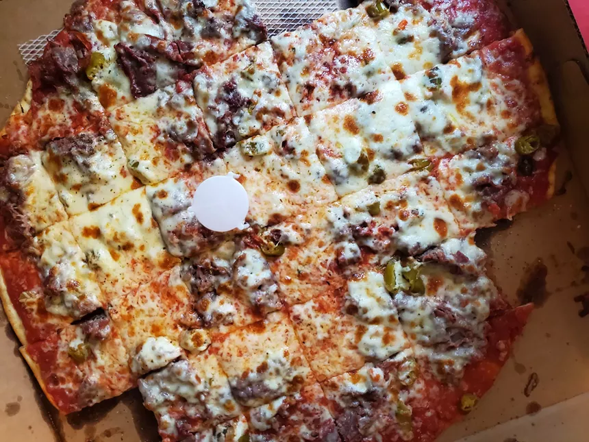 a pizza with square-cut slices
