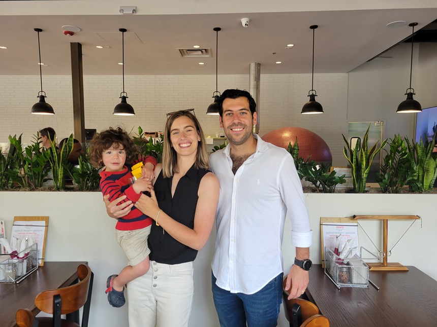 three adults and a child smiling in restaurant