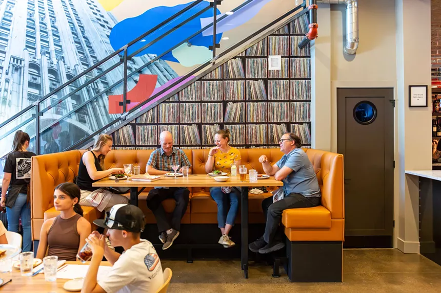people sitting in a large orange booth