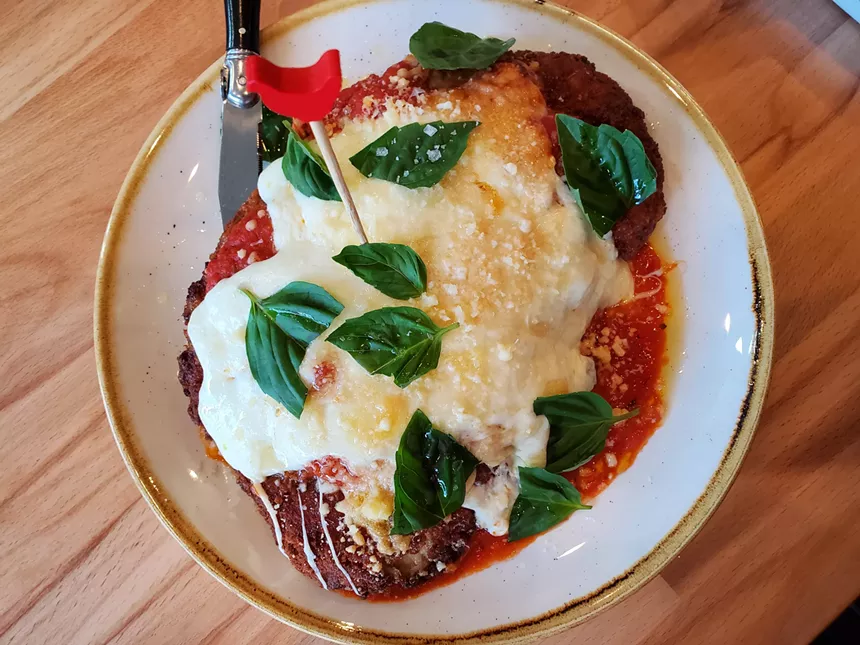 breaded and fried chicken topped with red sauce, mozzarella and basil