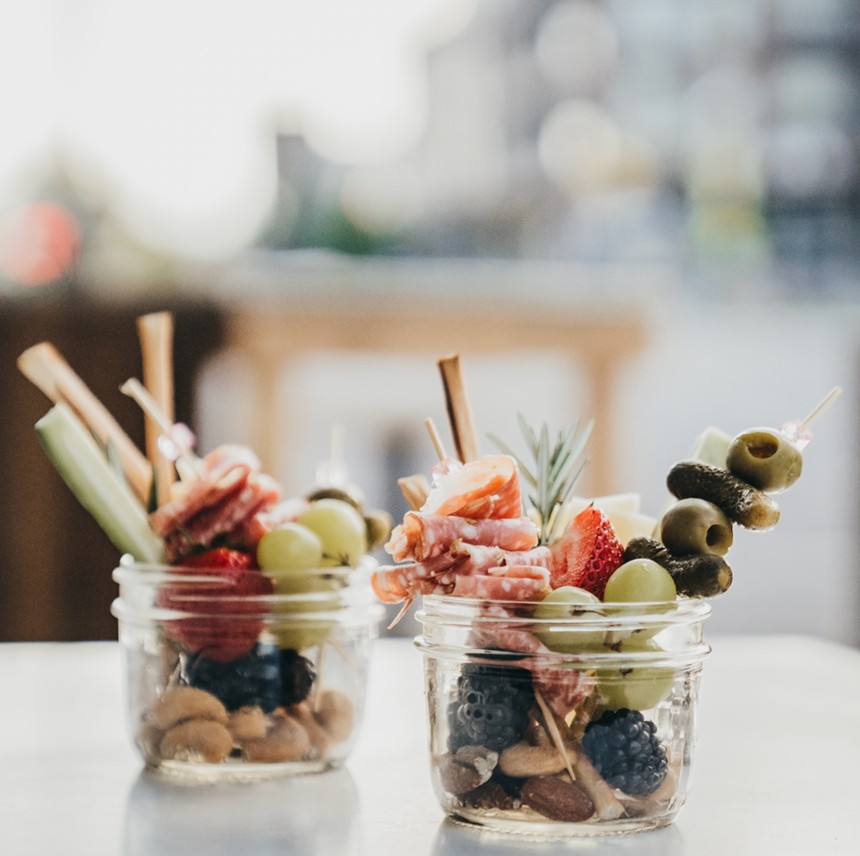 nuts, meat, fruit and olives in a jar