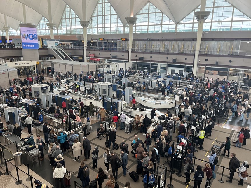 crowd by security at Denver International Airport