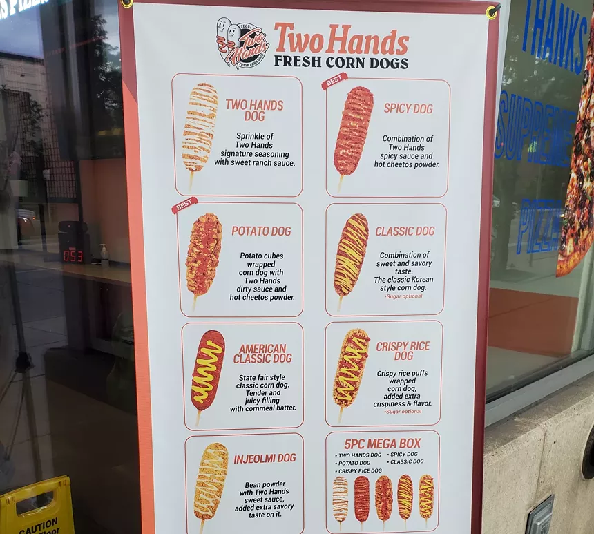 a sign with different corn dogs on it