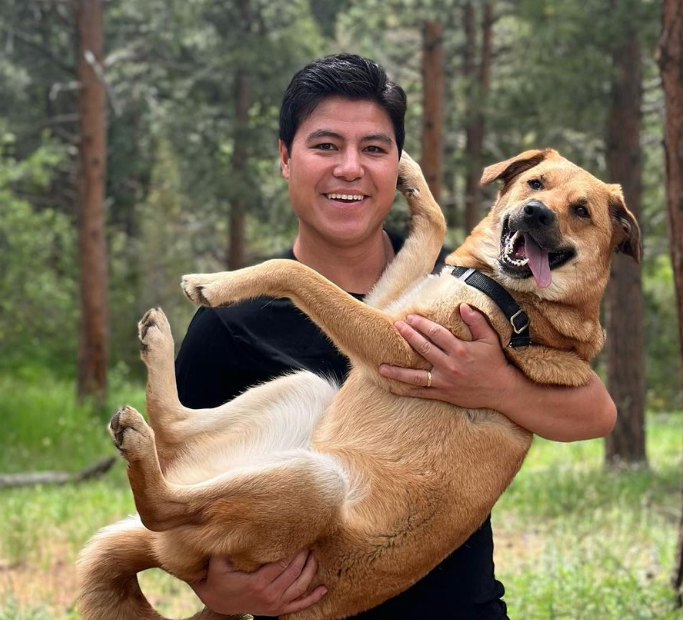 Denver7 anchor Bayan Wang holding his dog, Cedar.
