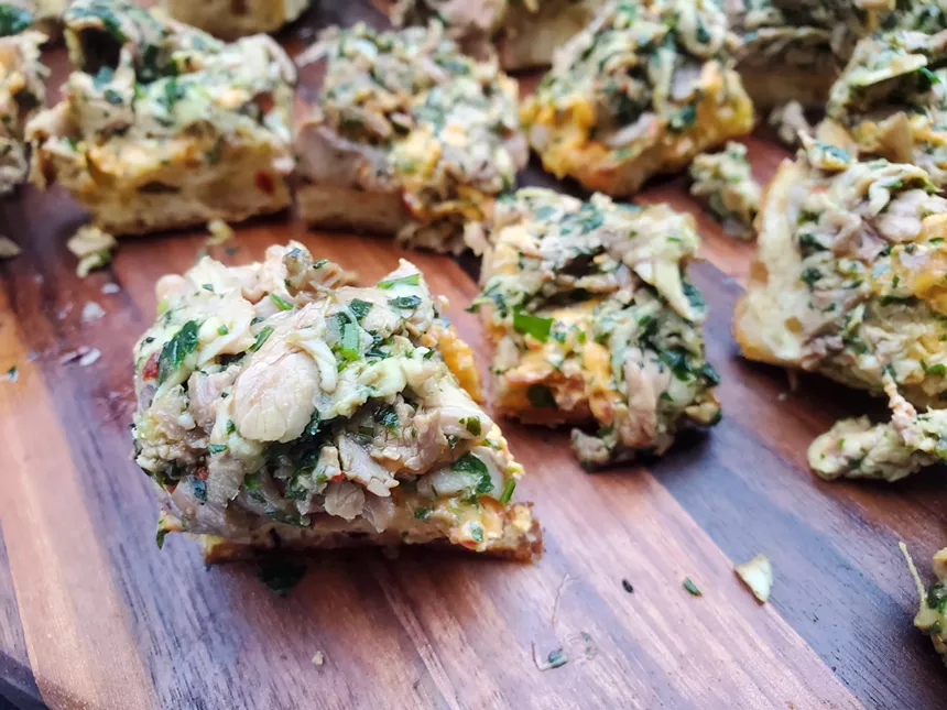 shredded meat on small pieces of bread
