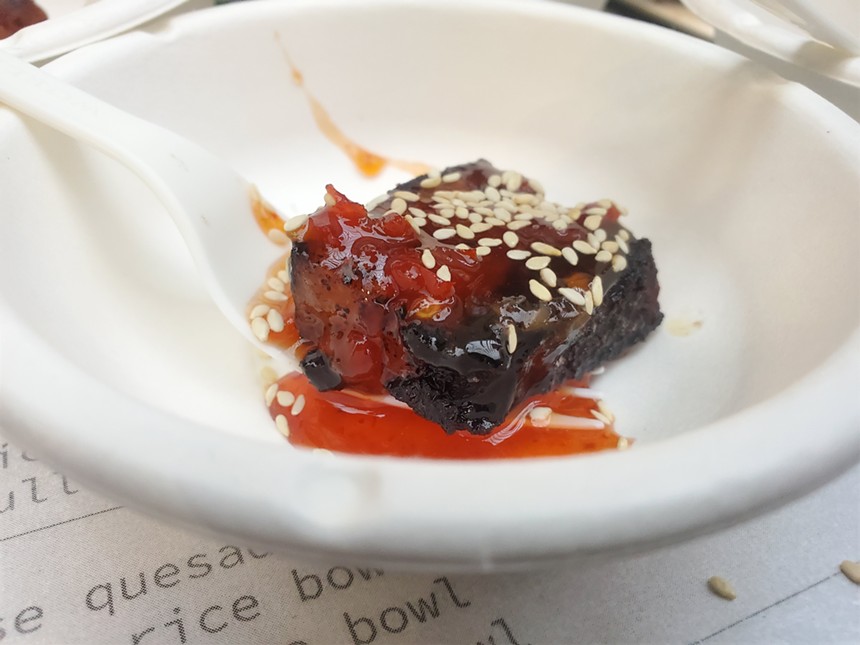 a piece of pork belly with red sauce