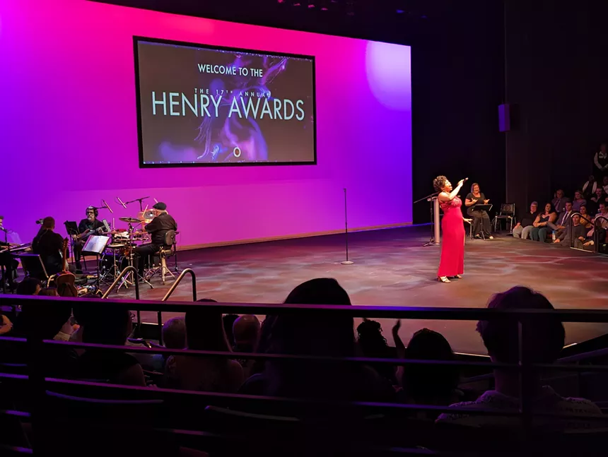 woman in red dress standing on stage