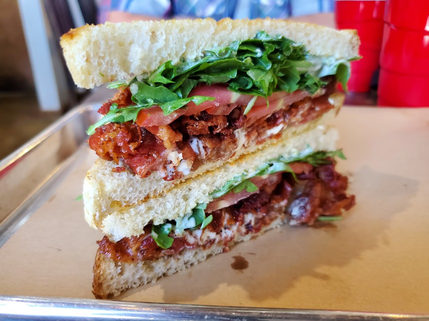 a bacon, lettuce and tomato sandwich on white bread