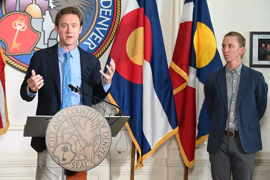 Mayor Mike Johnston talks to the press alongside Cole Chandler, his senior advisory on homeless resolution.