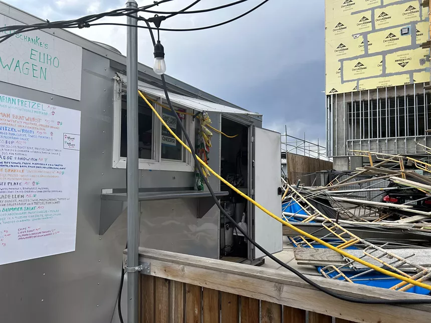 scaffolding on the ground next to a shipping container kitchen