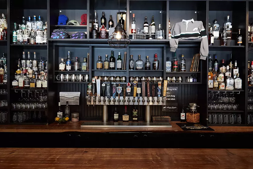 bottles on shelves behind a bar