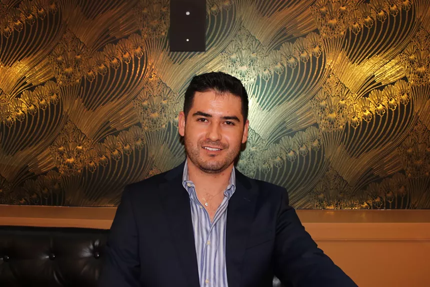 a man in a suit jacket and button up shirt