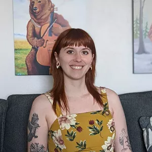 Lily Black smiles in a dress